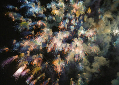 Nighttime fireworks display by explosives artist Cai Guo-Qiang bursting over the city skyline during the Earth to Space festival in Washington DC.