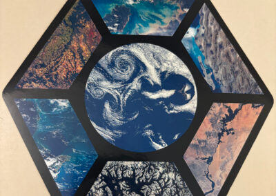 Hexagonal student artwork collage showcasing satellite photographs of Earth's oceans, mountains, and landforms.