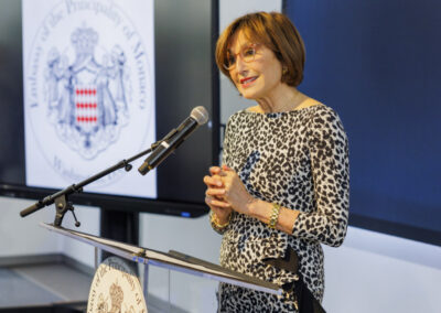 Speaker addressing guests at a podium during the Earth to Space reception hosted by the Embassy of Monaco.